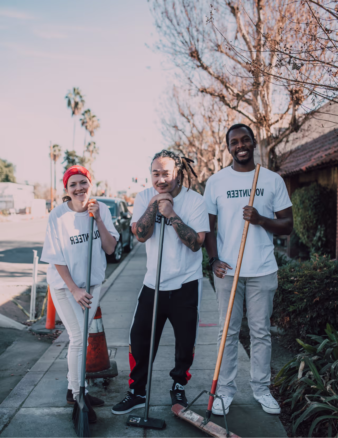 A group of people standing next to each other on a sidewalk